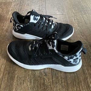 APL tennis shoes. Size 6. Black and white with cheetah accent.